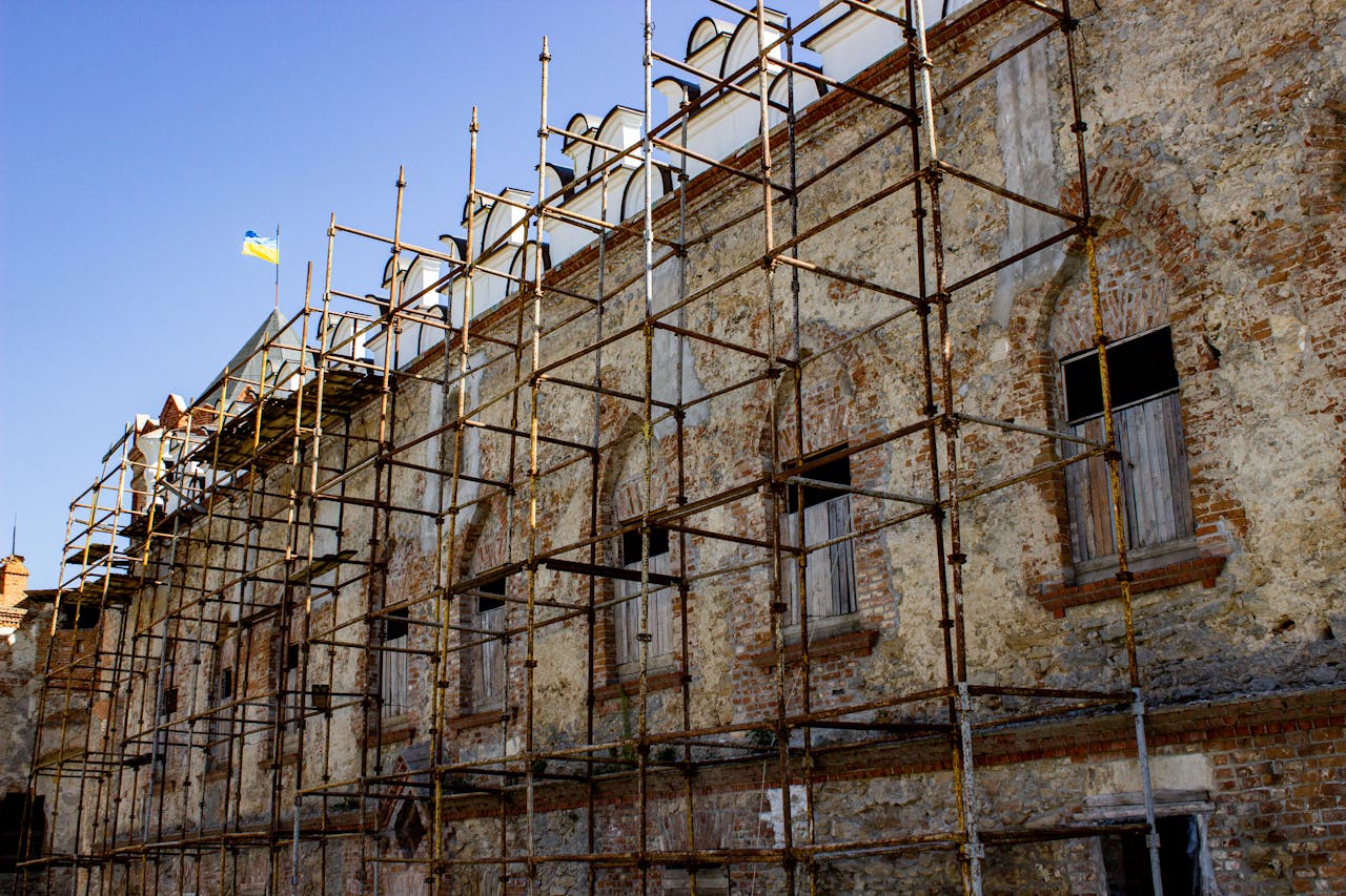 Crafting Captivating Headlines: Your awesome post title goes here Scaffolding set up on an old brick building under restoration, with a flag above.