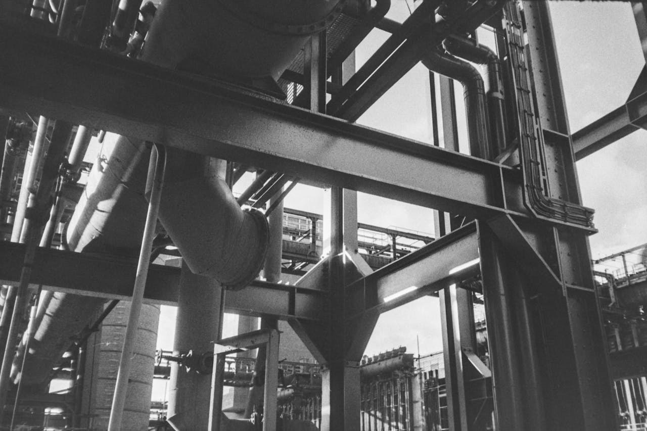 The Art of Drawing Readers In: Your attractive post title goes here A dramatic black and white shot of complex industrial pipes and metal structures.